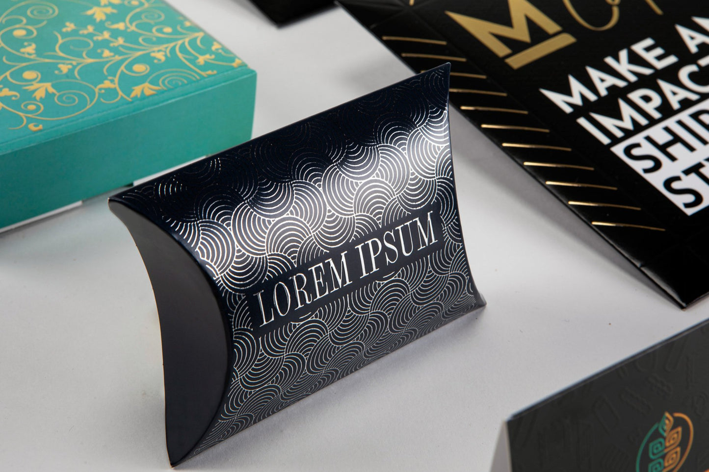 Focused image of a single black pillow box with silver special finishes.
