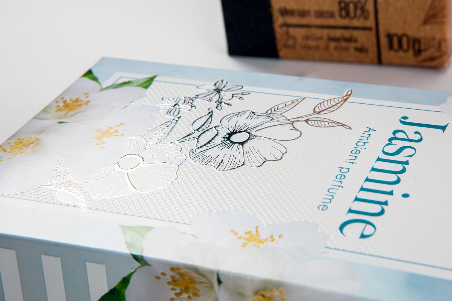 Horizontally placed box in white and light blue with silver special finishes.